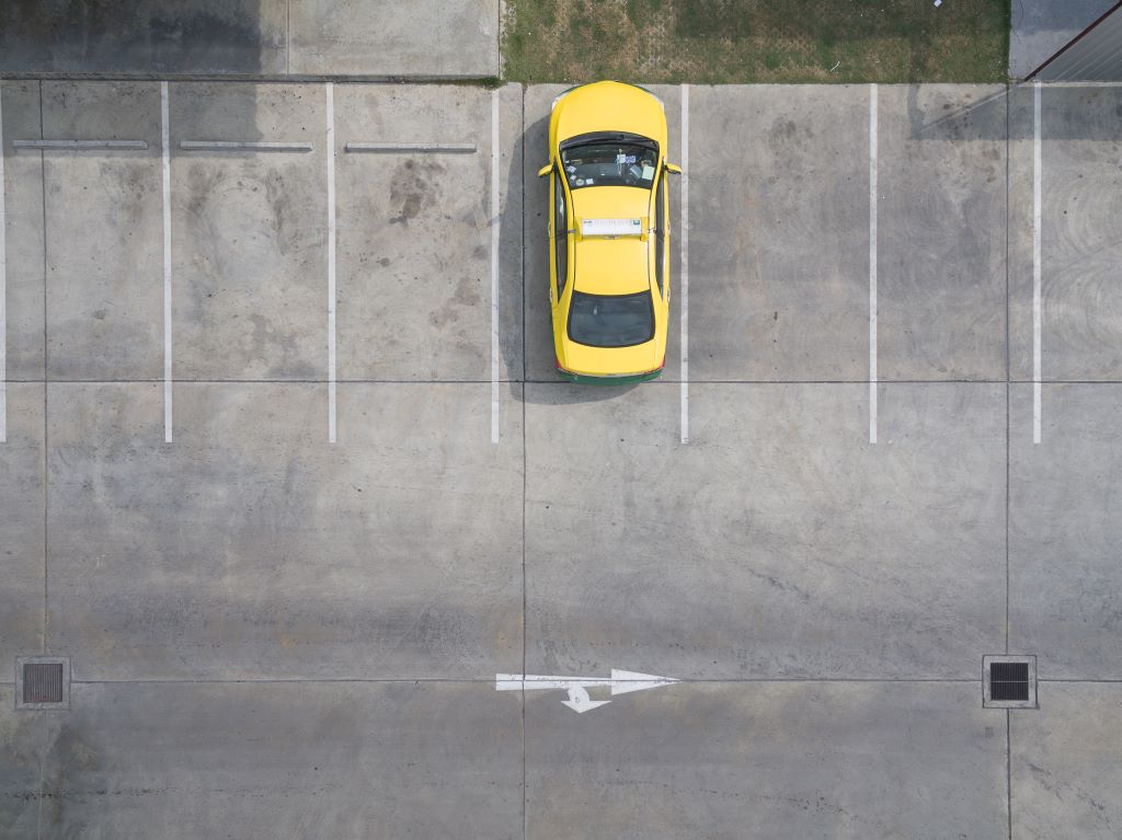 Smooth concrete parking lot with neatly painted lines in an urban setting